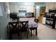 Eat-in kitchen with white cabinets, stainless appliances, and light-filled dining area at 2315 Redfern Dr, Indianapolis, IN 46227