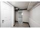 This basement hallway has plank flooring, neutral colored walls and a storage space at 2740 Pawnee Dr, Indianapolis, IN 46229