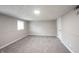 This basement has neutral colored walls, carpeted floor and a light for brightness at 2740 Pawnee Dr, Indianapolis, IN 46229