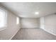 This basement has neutral colored walls, carpeted floor and a light for brightness at 2740 Pawnee Dr, Indianapolis, IN 46229