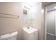 Bright bathroom featuring a toilet, single sink vanity and mirror at 2740 Pawnee Dr, Indianapolis, IN 46229