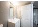 Neutrally decorated bathroom with white vanity, sink, mirror, and a towel ring at 2740 Pawnee Dr, Indianapolis, IN 46229