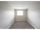Bedroom with neutral carpet and paint features a window and baseboard trim at 2740 Pawnee Dr, Indianapolis, IN 46229