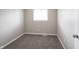 Cozy bedroom featuring a neutral carpet, small window, and baseboard trim at 2740 Pawnee Dr, Indianapolis, IN 46229