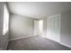 This bedroom has neutral colored walls, soft carpet, and ample closet space at 2740 Pawnee Dr, Indianapolis, IN 46229