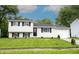 Charming split-level home with a well-manicured lawn and attached one car garage at 2740 Pawnee Dr, Indianapolis, IN 46229