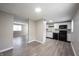 Modern kitchen featuring white cabinets, black appliances, and a view of the living room at 2740 Pawnee Dr, Indianapolis, IN 46229
