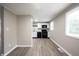 Modern kitchen featuring white cabinets, black appliances, and a view of the living room at 2740 Pawnee Dr, Indianapolis, IN 46229