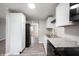 Bright kitchen features stainless steel sink, white cabinets and black appliances at 2740 Pawnee Dr, Indianapolis, IN 46229