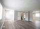 Spacious living room with wood-look flooring and view of kitchen at 2740 Pawnee Dr, Indianapolis, IN 46229