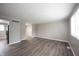 Living room featuring wood-look flooring, neutral paint, and large window at 2740 Pawnee Dr, Indianapolis, IN 46229