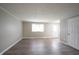 Living room featuring wood-look flooring, neutral paint, and large window at 2740 Pawnee Dr, Indianapolis, IN 46229