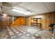 Unfinished basement space with wood paneling, a staircase, and potential for customization and storage at 301 N Kitley Ave, Indianapolis, IN 46219