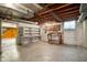 Unfinished basement with concrete flooring, wooden ceiling and shelves at 301 N Kitley Ave, Indianapolis, IN 46219