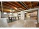 Spacious basement featuring exposed ceiling, ping pong table, and shelving units at 301 N Kitley Ave, Indianapolis, IN 46219