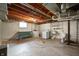 Basement with laundry area, utility sink, and exposed ductwork at 301 N Kitley Ave, Indianapolis, IN 46219