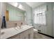 Charming bathroom with pastel striped wallpaper, vintage fixtures, and bright window, offering a relaxing space at 301 N Kitley Ave, Indianapolis, IN 46219