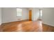 Comfortable bedroom with hardwood floors, bright windows, and a closet, perfect for restful nights at 301 N Kitley Ave, Indianapolis, IN 46219