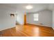 Bright bedroom featuring hardwood floors, ample natural light, and a neutral color scheme, offering a serene retreat at 301 N Kitley Ave, Indianapolis, IN 46219