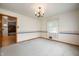 Empty dining room featuring a chandelier, wallpaper border, and a view of the kitchen at 301 N Kitley Ave, Indianapolis, IN 46219