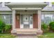 Close-up of the front porch featuring decorative columns and the front door at 301 N Kitley Ave, Indianapolis, IN 46219