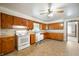 Traditional kitchen with wooden cabinets, white appliances, and a tiled floor, offering a functional cooking space at 301 N Kitley Ave, Indianapolis, IN 46219
