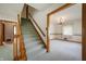 Carpeted staircase leading to the upper level, adjacent to a doorway into the dining room at 301 N Kitley Ave, Indianapolis, IN 46219