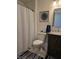 Well-lit bathroom with a shower, vanity with sink, toilet, and coordinated decor at 310 Styleline Dr, Mooresville, IN 46158