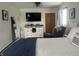 Cozy bedroom featuring soft lighting, and closet with wood doors, TV, dresser and comfortable furnishings at 310 Styleline Dr, Mooresville, IN 46158