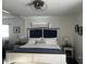 Bright bedroom boasts a plush bed with blue accents, bedside tables and unique lighting at 310 Styleline Dr, Mooresville, IN 46158
