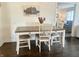 Dining area with stylish table and chairs, hardwood floors, and a view to the living area at 310 Styleline Dr, Mooresville, IN 46158