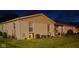 Exterior shot of single-story home at night with lights along the front bushes at 310 Styleline Dr, Mooresville, IN 46158