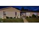 Inviting single-story home with a well-lit exterior and cozy front porch at night at 310 Styleline Dr, Mooresville, IN 46158