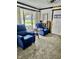 Cozy sitting area with blue recliners, a small round table, and a view to the outside patio at 310 Styleline Dr, Mooresville, IN 46158