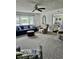 Bright living room featuring a comfortable blue sofa, ottoman, and plush gray carpeting at 310 Styleline Dr, Mooresville, IN 46158