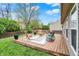 Inviting backyard with a wooden deck, brick patio, and lush green grass at 3214 Limber Pine Dr, Whiteland, IN 46184