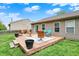 Expansive backyard with a wooden deck, patio furniture, and manicured lawn at 3214 Limber Pine Dr, Whiteland, IN 46184