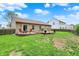 Large backyard featuring a wooden deck, brick patio, and green lawn at 3214 Limber Pine Dr, Whiteland, IN 46184