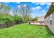 Spacious backyard with a wooden deck, green lawn, surrounded by a wood fence and trees at 3214 Limber Pine Dr, Whiteland, IN 46184