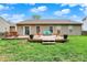 Large backyard featuring a wooden deck, brick patio, and green space at 3214 Limber Pine Dr, Whiteland, IN 46184
