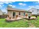 Well-appointed backyard with a brick patio, wooden deck, and manicured lawn at 3214 Limber Pine Dr, Whiteland, IN 46184