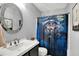 Bathroom featuring a sink with black cabinets and a bathtub with a whimsical dog shower curtain at 3214 Limber Pine Dr, Whiteland, IN 46184
