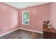 Cozy bedroom with natural light, light pink walls, and hardwood flooring at 3214 Limber Pine Dr, Whiteland, IN 46184