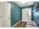Bright entryway featuring wood-look floors, modern lighting, and a charming bench with storage at 3214 Limber Pine Dr, Whiteland, IN 46184