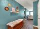 Inviting entryway with decoratively painted walls, wood-look floors, storage bench, and stylish wall decor at 3214 Limber Pine Dr, Whiteland, IN 46184