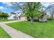 Inviting home with a well-manicured lawn, two-car garage, and mature tree providing shade at 3214 Limber Pine Dr, Whiteland, IN 46184