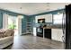 Charming kitchen featuring sleek black appliances, white cabinetry, and easy backyard access at 3214 Limber Pine Dr, Whiteland, IN 46184