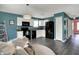 Bright kitchen with black appliances and white cabinetry provides an eat-in area and ample storage at 3214 Limber Pine Dr, Whiteland, IN 46184