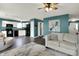 Open-concept living room with modern decor, comfortable seating, and view into the kitchen at 3214 Limber Pine Dr, Whiteland, IN 46184