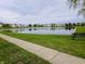 Scenic pond view reflecting nearby homes, lush greenery, and a peaceful walkway at 3214 Limber Pine Dr, Whiteland, IN 46184